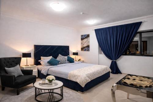 a bedroom with a bed and a blue curtain at Panoramic Sea apartment & Skyline View Private Room in Sharjah