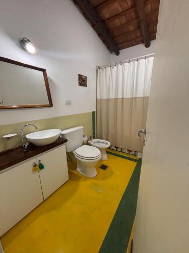 a bathroom with a toilet and a sink at Villa Pellegrini in Trapiche
