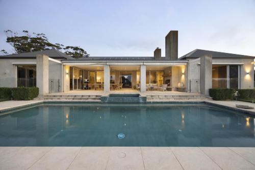 an exterior view of a house with a swimming pool at Edgewater in Balnarring Beach