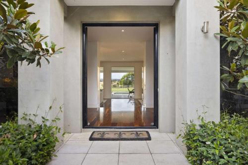 an open door of a house with a hallway at Edgewater in Balnarring Beach