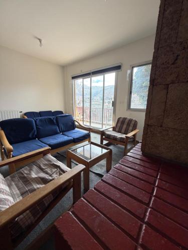 a living room with a blue couch and chairs at Faraya square chalet in Fārayyā