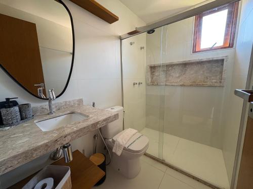 a bathroom with a shower and a sink and a toilet at Diamantino Residence - apt 07 CalmariaMucuge in Mucugê