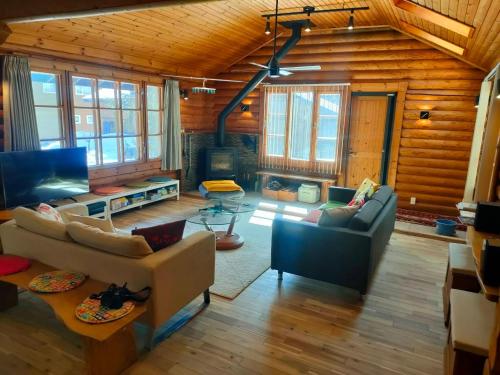 a living room with a couch and a table at LOG-INN Hakuba in Hakuba