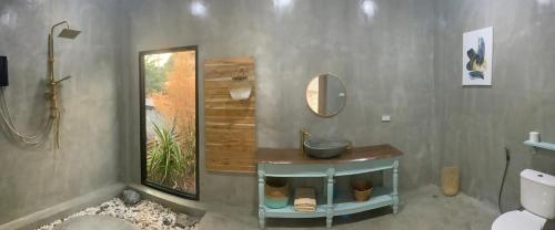 a bathroom with a sink and a mirror at Studio Thakhek-private loft with terasse in Thakhek