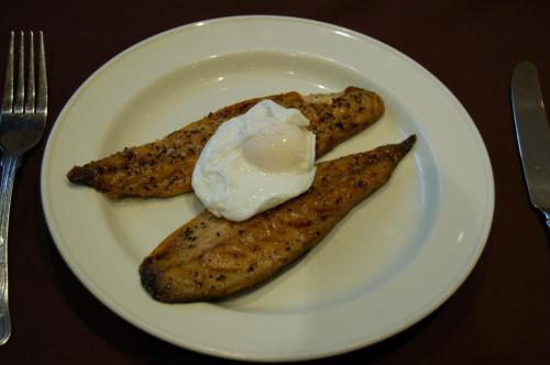 a white plate with two pieces of food on a table at The Wight in Sandown