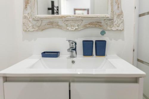 a bathroom with a white sink and a mirror at Studio le nid avec piscine partagée in Flayosc