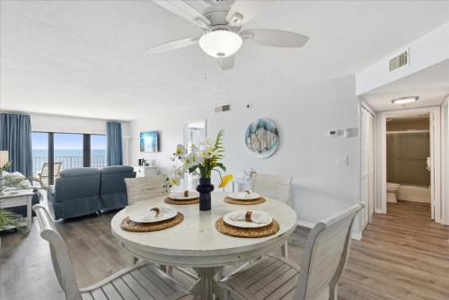a dining room and living room with a table and chairs at Boardwalk 401 in Cocoa Beach