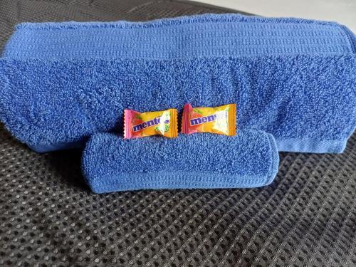 two packets of toothpaste sitting on top of a blue towel at Wattleview in Lithgow