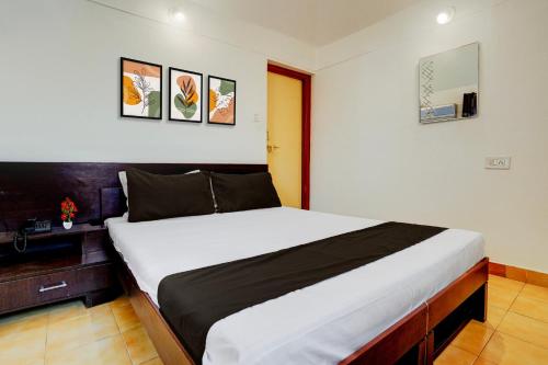 a bedroom with a large bed in a room at Townhouse Amrapali Resort in Kolhapur
