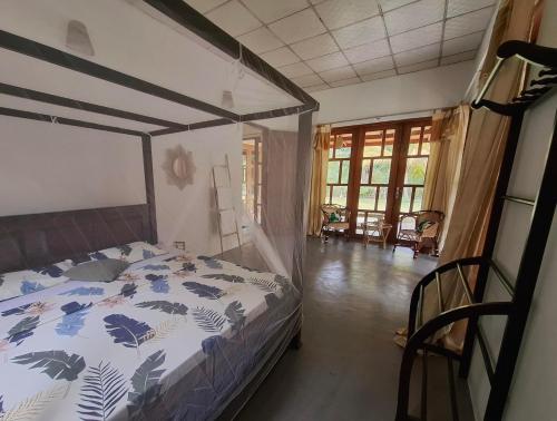 a bedroom with a bed with a canopy at Sansayin Homestay in Hambantota