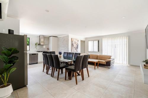 a kitchen and dining room with a table and chairs at Brand new fully accessible 5 bedroom house in Fairfield