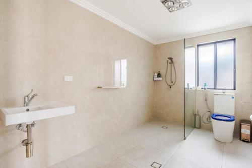 a bathroom with a toilet and a sink and a shower at Brand new fully accessible 5 bedroom house in Fairfield