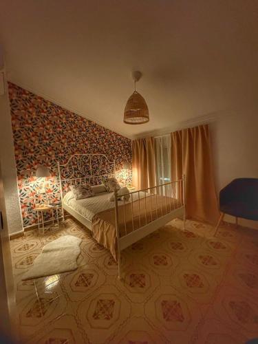 a bedroom with a bed in a room with a wall at Las Casitas de Cullera Sol y Mar in Cullera