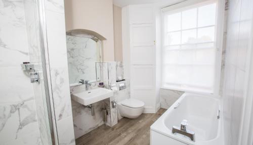a white bathroom with a toilet and a sink at Arden House - Eden Hotel Collection in Stratford-upon-Avon