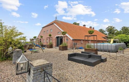 a home with a playground in front of a house at Hunting Lodge in Detern