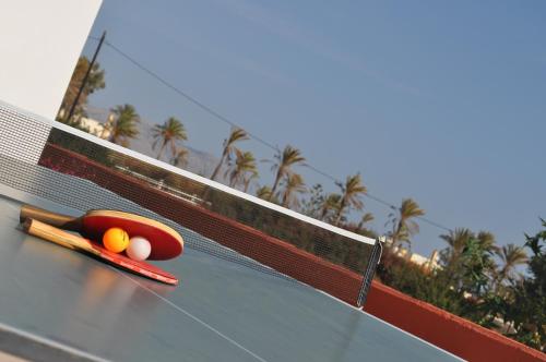 a pair of chopsticks and balls on top of a tennis racket at Villa Imerti Kiotari in Kiotari