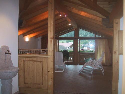 a room with chairs and a large window in a house at Hotel Garni Elisabeth in Zell am Ziller