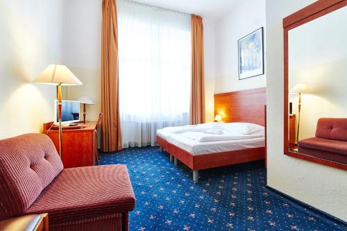 En eller flere senge i et værelse på Hotel Europa City