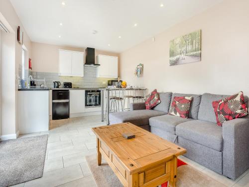 a living room with a couch and a table at Jemmett Lodge in Kent