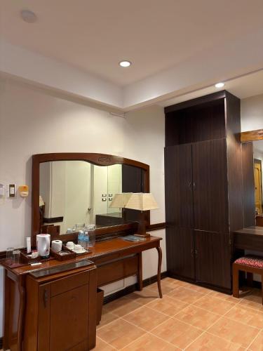 a room with a desk and a large mirror at Hotel Grand Luis in Dauis