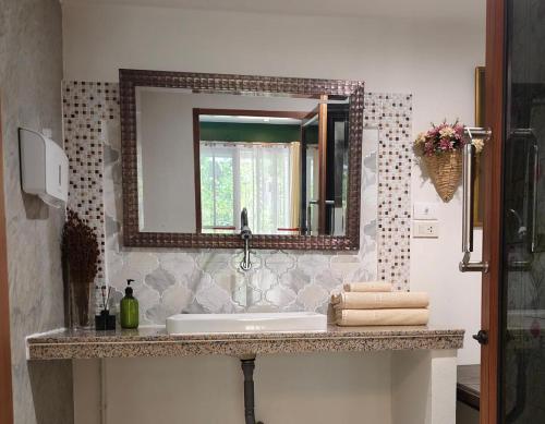 a bathroom with a sink and a mirror at Phu View Hideaway in Ban Kham Proi