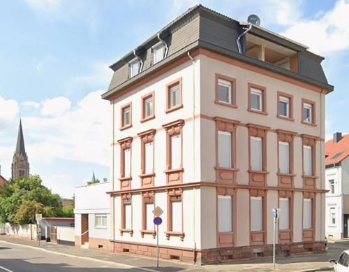 a large white building on the corner of a street at COZEE - Spacious Apartment With Netflix in Kaiserslautern