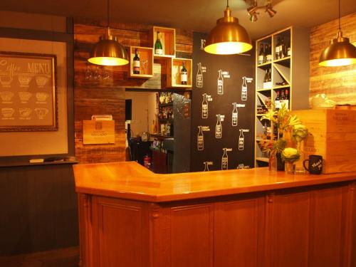 a bar with a wooden counter in a restaurant at Black Swan Inn in Masham