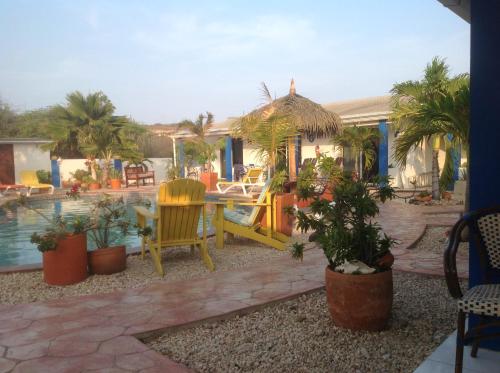 a patio with a table and chairs and a pool at Hacienda Wayaca Apartments in Wayaca