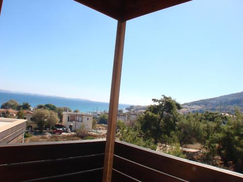 a view of the ocean from the balcony of a house at AnnaDes Apartments & Studios Chios in Karfas
