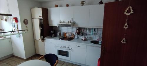 a kitchen with white cabinets and a sink at Steffi in Hannover