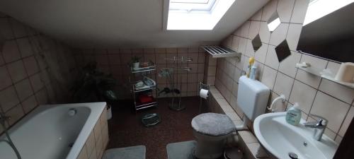 a bathroom with a sink and a tub and a toilet at Steffi in Hannover