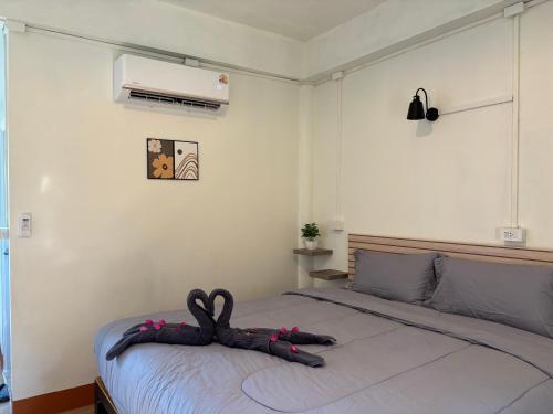 a bedroom with a bed with a stuffed animal on it at The cozy house in Trang