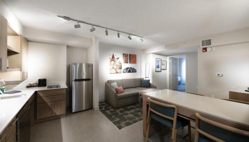 a kitchen and living room with a refrigerator and a couch at Homewood Suites by Hilton Atlanta Buckhead Pharr Road in Atlanta