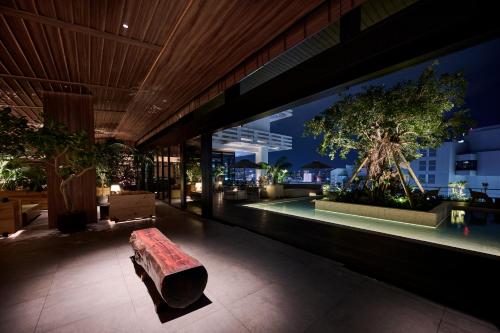 a bench sitting inside of a building at night at The Royal Park Hotel Iconic Naha in Naha