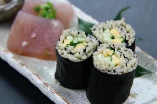 three rolls of sushi on a plate with watermelon at Fukuichi in Nambu