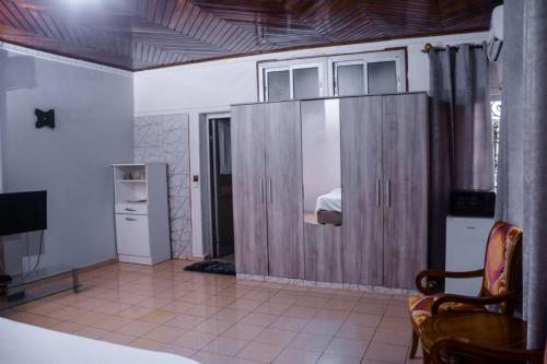 a bedroom with a large wooden cabinet with a bed at PEACE GUEST HOUSE in Yaoundé