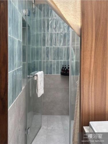 a bathroom with a shower with a glass door at Light Room in Tainan