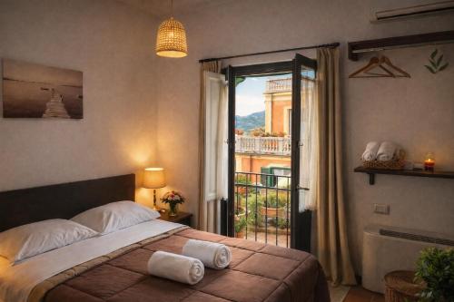a bedroom with a bed and a view of a balcony at Hotel Ristorante Poseidonia in Sapri