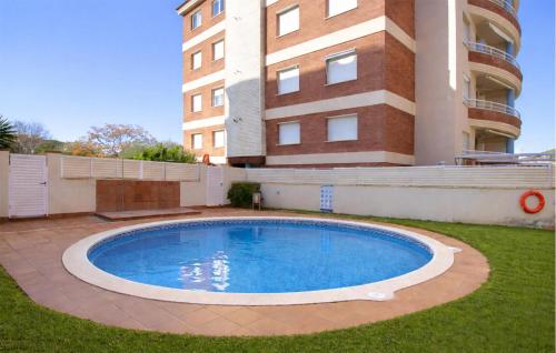 a large swimming pool in front of a building at Gorgeous Apartment In Calafell With Swimming Pool in Calafell