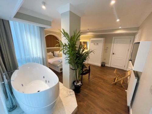 a bathroom with a large bath tub in a room at DBD Hotel Bayraklı in Bayrakli