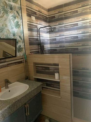 a bathroom with a sink and a mirror at THE OASIS RESORT CondoBimbo 1-Big Room, Balcony, kitchen, Pool, Wifi, Videoke in San Fernando
