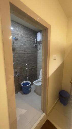 a bathroom with a toilet and a sink and a shower at Sithara Grand in Ongole