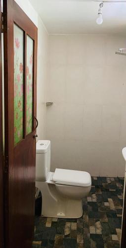 a bathroom with a toilet in a room at Villa Indeewara in Welipenna East