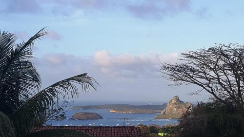a view of the ocean with rocks in the water at Flat Visual do Porto in Fernando de Noronha