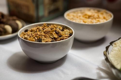 three bowls of cereal sitting on a table at Pousada Areias do Rosa in Praia do Rosa