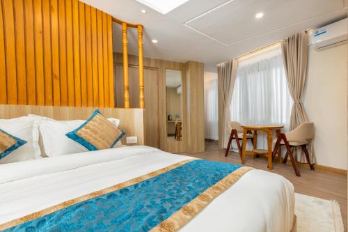a bedroom with a large bed and a table at Tritara Apartment in Kathmandu