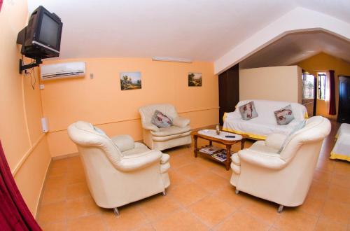 a therapy room with two chairs and a tv at SM Lodge in Trou dʼ Eau Douce