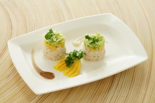 a white plate with three different types of food on it at Kew Hotel Tagbilaran in Tagbilaran City