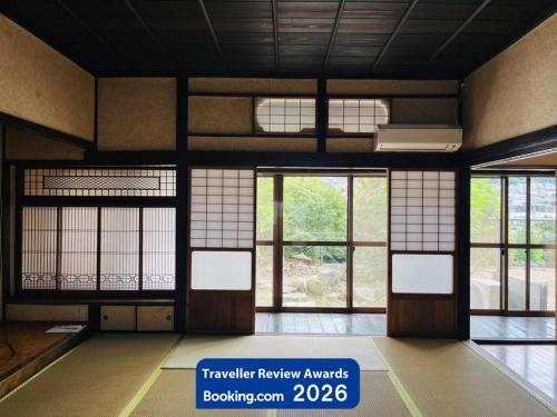 a room with doors and windows in a building at 1日1組1棟貸 5LDKお洒落古民家 駐車場2台付 "一休庵" Traditional house with yard and parking in Hiroshima