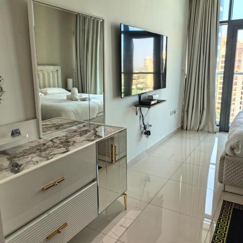 a bathroom with a dresser with a mirror and a bed at 7 Palm Jumeirah in Dubai